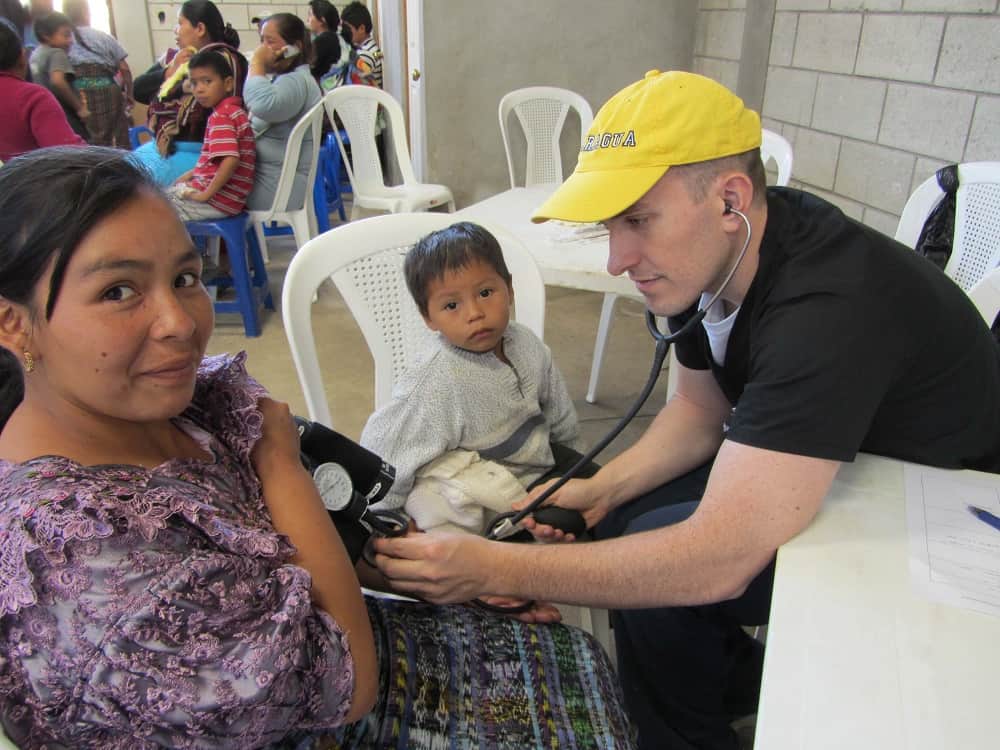 checking blood pressure on medical mission in Guatemala 2013